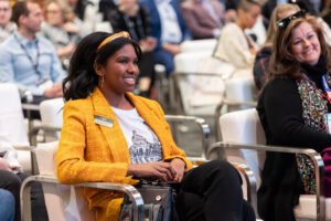 Participant full of smiles while listening to the discussion