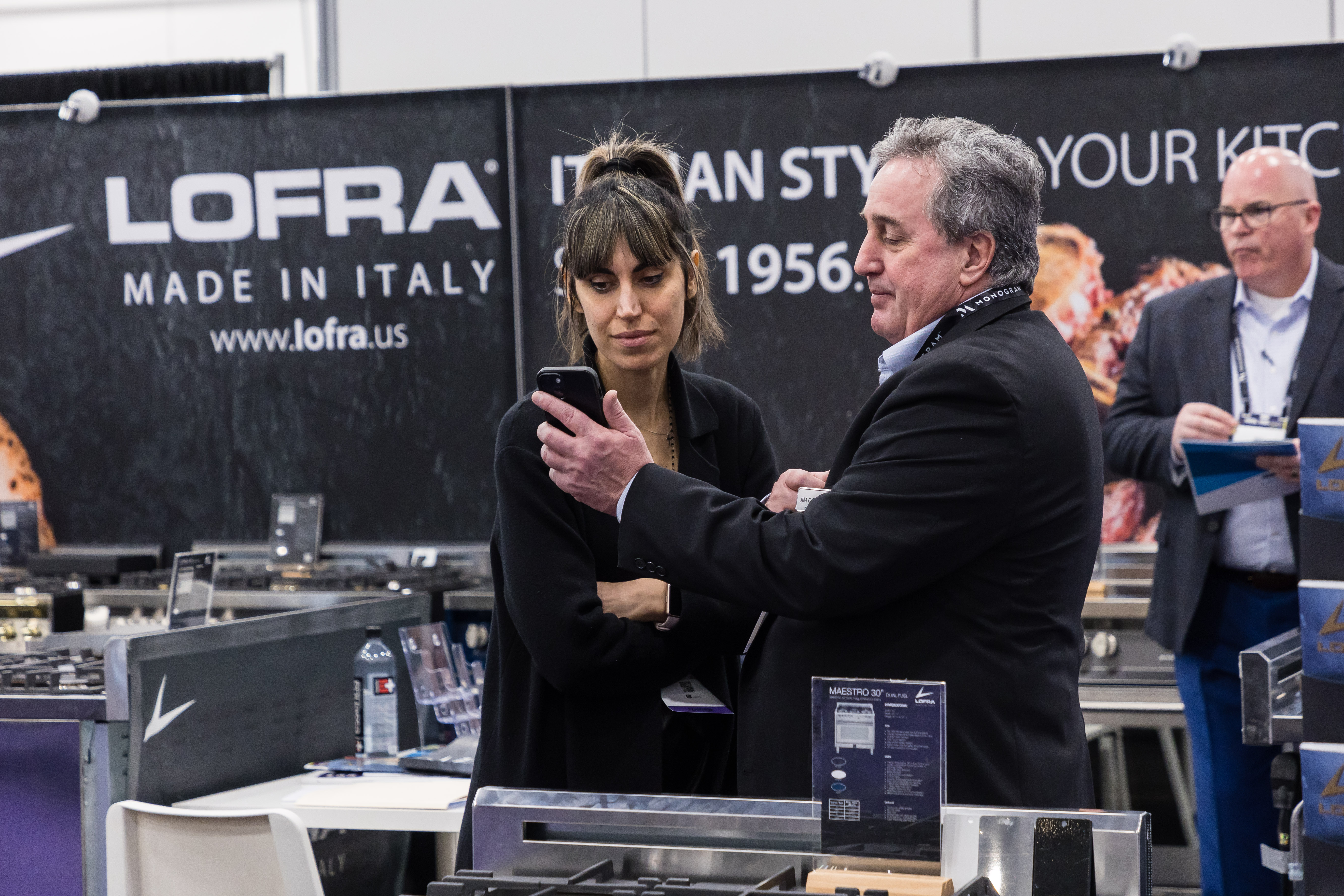A man showing a woman an image on his phone.