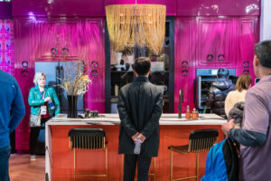 A man admiring a colorful and vibrant kitchen interior design booth at KBSIS 2023