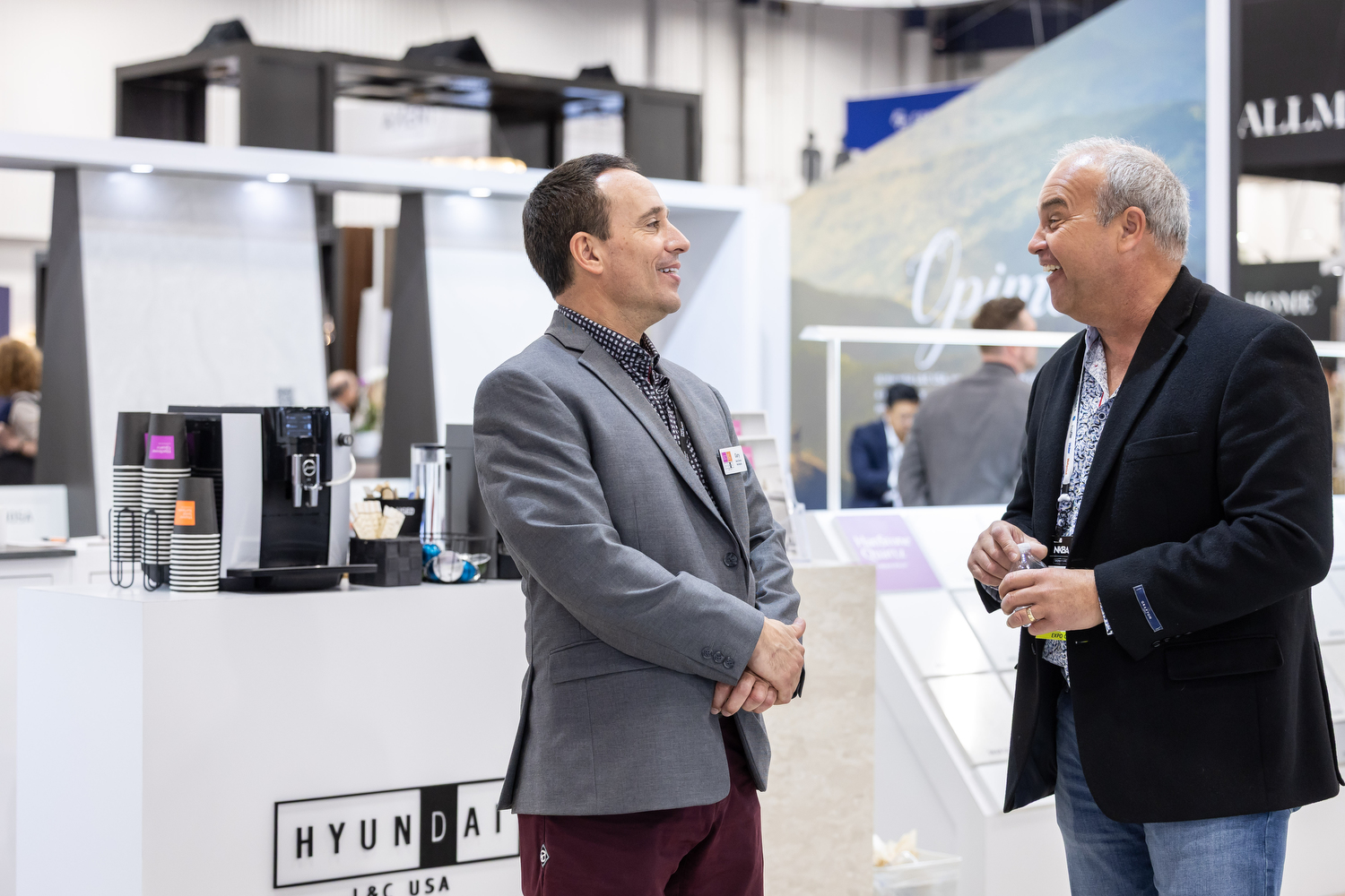 Designers discuss products at a beautiful booth in Discovery District at KBIS