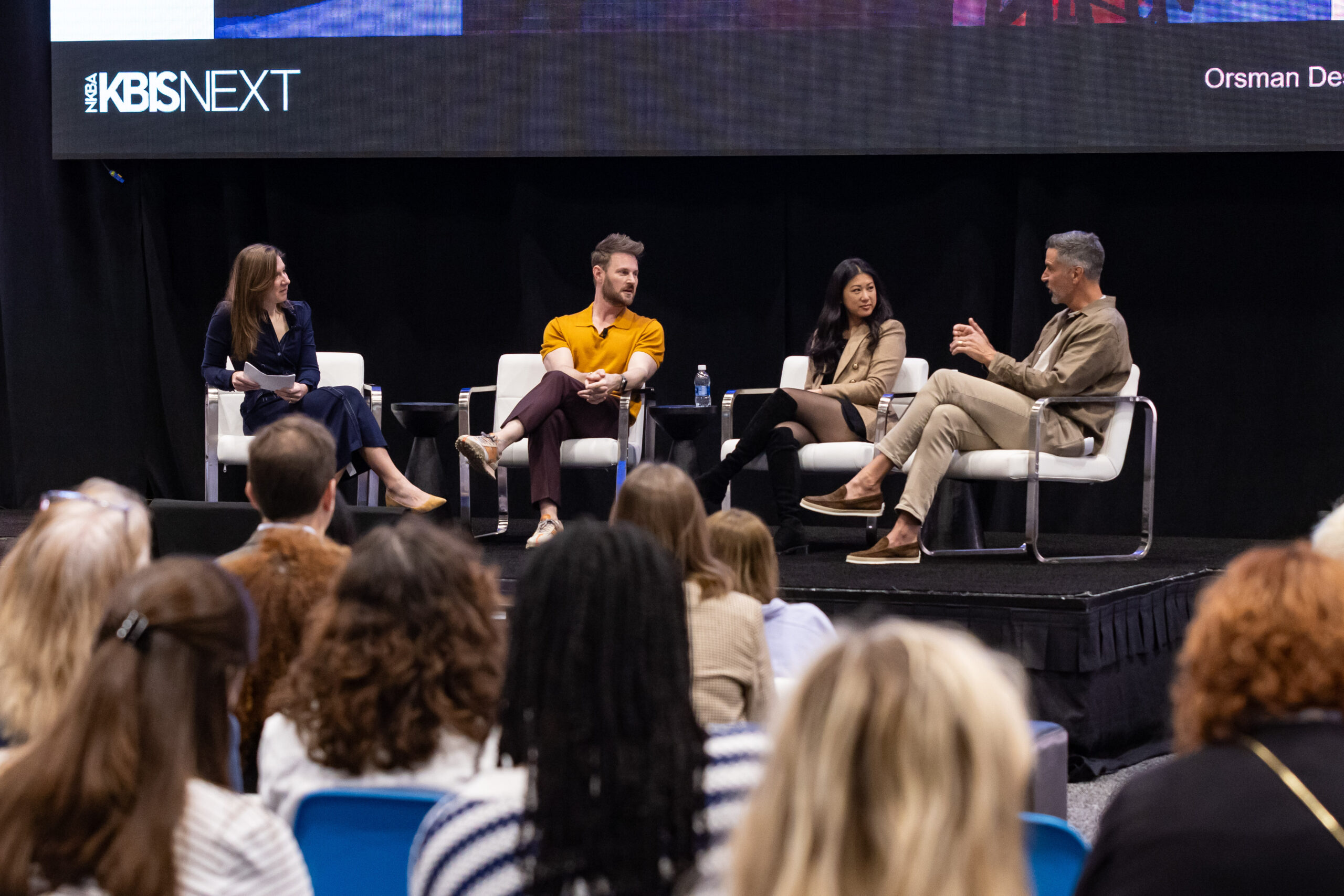 A Best of KBIS judge presents an award on stage at KBIS 2024.