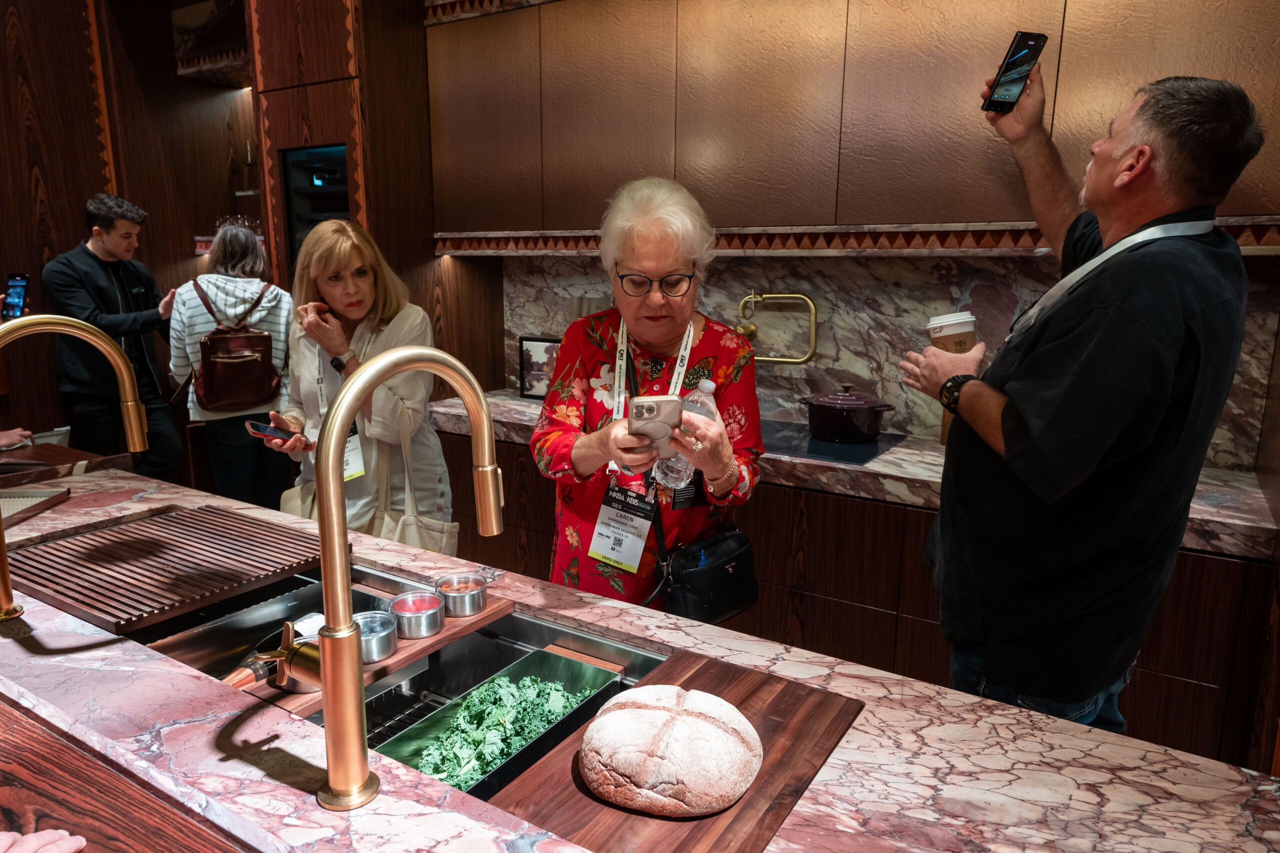 An exhibitor shows attendees the inside of a fridge at KBIS 2024