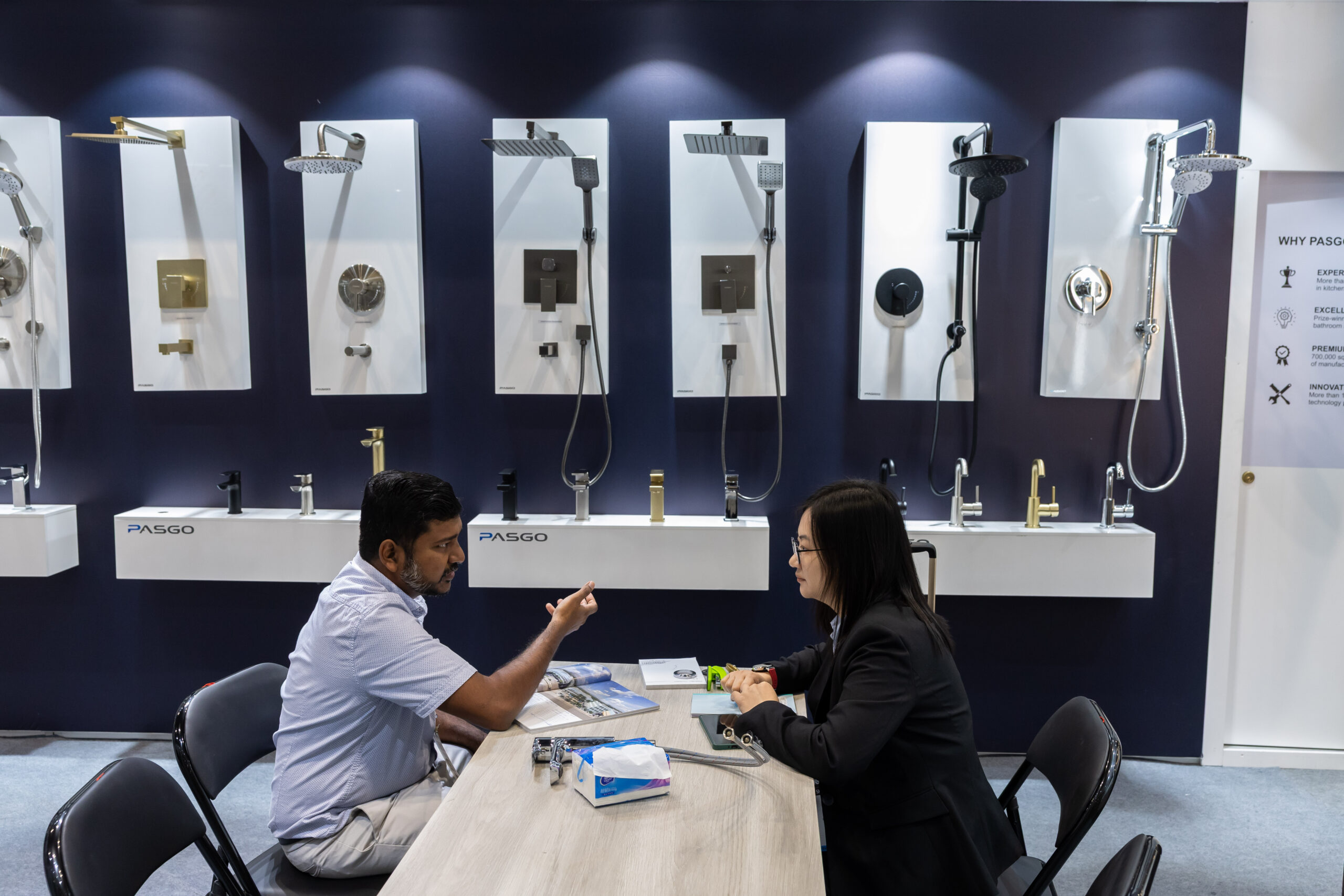 A woman examines a shelf drawer at KBIS 2024